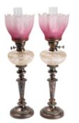 A pair of Victorian silver plated metal and glass table oil lamps,