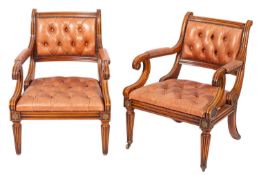 A pair of walnut, repousse metal mounted and buttoned leather upholstered library elbow chairs