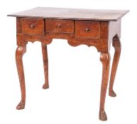 A George II oak 'lowboy' side table, mid 18th century; the top with moulded edges,