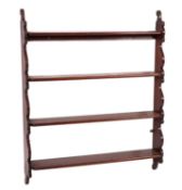 A set of early Victorian mahogany open wall shelves,