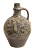 *David Leach [1911-2005] a stoneware ewer with ribbed neck and applied ribbed strap handle with