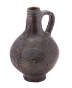 A salt glazed Bellarmine or Bartmann Krug of typical bellied form the neck embossed with a bearded