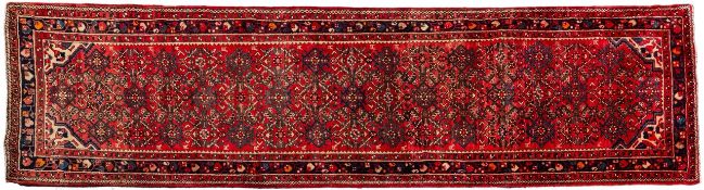 A Melayer runner, the rose field with an allover geometric lozenge design,