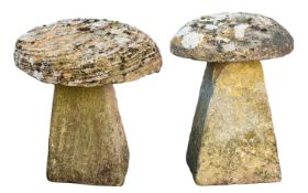 Two rough hewn limestone staddle stones with caps,