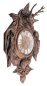 A substantial French Victorian carved wall clock the eight-day duration movement striking the hours