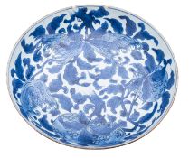 A large Chinese blue and white saucer dish, Kangxi painted with branches of peach and finger citron,