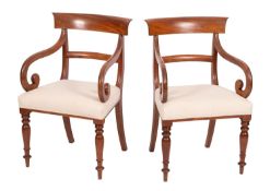 A pair of Regency mahogany and upholstered library elbow chairs,