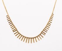 A fringe necklace, a flat Cuban style link chain to a graduated 'fringe' centrepiece,