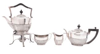 An early 20th century matched four-piece silver tea set, oval form,