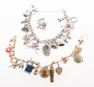 Two charm bracelets, a 9ct. gold example, fitted with gold, gilt-metal and gem material charms
