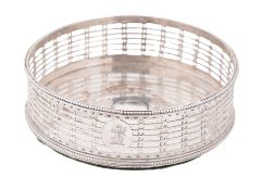 A George III silver wine coaster, circular form, with bead borders and pierced sides (loaded base),