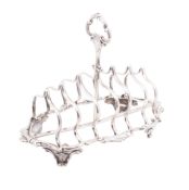 A Victorian silver toast rack, shaped oval outline, with a scroll border,