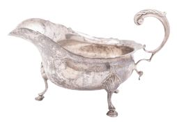 A George V silver sauce boat, shaped oval form, with a wavy rim,