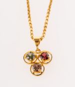 A three stone pendant with chain, the pendant of openwork trefoil design,