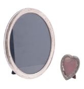 A modern silver mounted photograph frame, oval form and with an easel back,