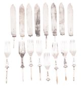 An Edwardian set of eight pairs of silver fish knife & fork blades, all lacking their handles,