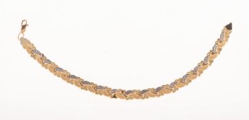 An articulated bracelet, of bi-colour interwoven links, each with a polished,