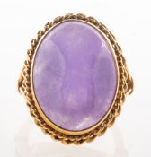 A lavender jade cocktail ring, collet set with a large oval-cut lavender jade cabochon,
