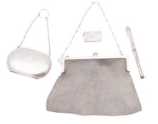 A George V silver mesh purse, with a suspensory chain and inscribed 