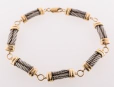 A bi-colour fancy link bracelet, of seven slightly curved white metal rope twist design links,
