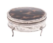A George V silver dressing table box, shaped oval outline,