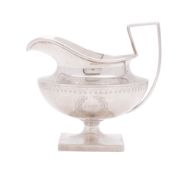 A late 19th/ early 20th century North American silver milk jug, circular form,