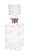 An Elizabeth II silver mounted clear cut-glass decanter, in the form of a block,