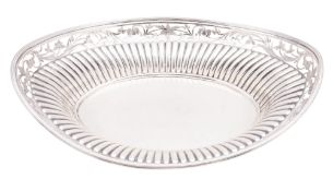 A late Victorian silver bread basket, of navette outline,