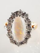 An opal and diamond cluster ring, of oval form,