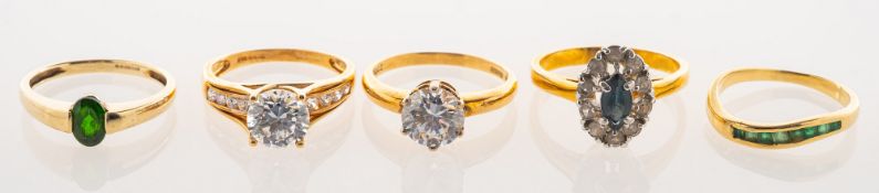 A group of five rings, including a 14ct gold solitaire style ring, claw set with a cubic zirconia,