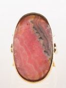 A rhodochrosite ring, collet set with an oval-cut rhodochrosite, measuring approx. 28.0mm x 16.