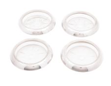 A late 19th/ early 20th century set of four North American silver mounted clear glass coasters,