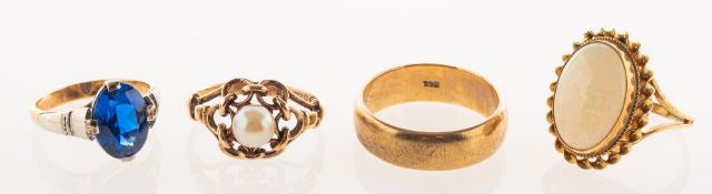 A group of four rings, including a 9ct gold oval-cut opal cabochon dress ring in a rope twist mount,