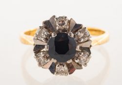 An 18ct yellow and white gold sapphire and diamond cluster ring, of flower head form,