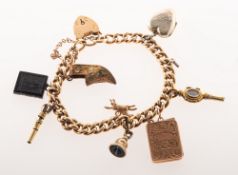 A charm bracelet with charms, the bracelet of curb links with a heart padlock and safety chain,