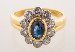 An 18ct yellow and white gold sapphire and diamond cluster ring,