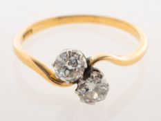 A 'toi et moi' diamond two stone ring, claw set on a twist band with two old-cut diamonds,