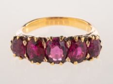 A five stone ruby ring, claw set with five graduated oval-cut rubies,