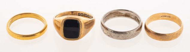 A group of four rings, including a 9ct gold onyx set signet ring, UK hallmark, size L, 3.