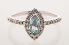 An 18ct gold aquamarine and diamond halo ring, of navette form,