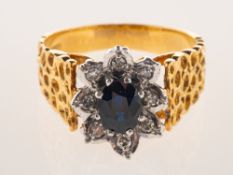 A sapphire and diamond cluster ring, a vintage flower head cluster style ring,