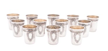 A set of twelve late 19th/ early 20th century French silver tot cups or beakers,