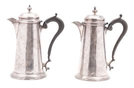 A near matched pair of early 20th century silver café-au-lait pots, tapering circular form,