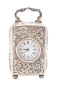 A late Victorian silver gilt carriage timepiece, of rounded rectangular form, with a swing-handle,