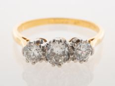 A three stone diamond ring, claw set with three old-cut diamonds, the centre diamond being approx.