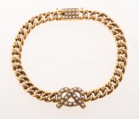 A Victorian bracelet with a pearl set knot and clasp,