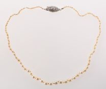 An antique cultured pearl necklace with diamond set clasp,