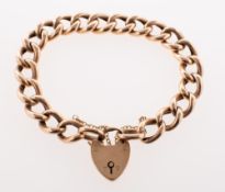 A curb link bracelet, with heart padlock and safety chain, marked 9ct to verso of heart padlock,