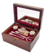 An Edwardian Art-Nouveau cased eight-piece dressing set, with embossed stylised decoration,