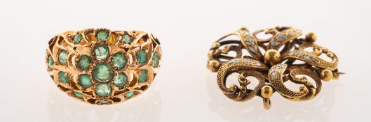 An antique emerald ring and a Victorian enamelled Krementz brooch,